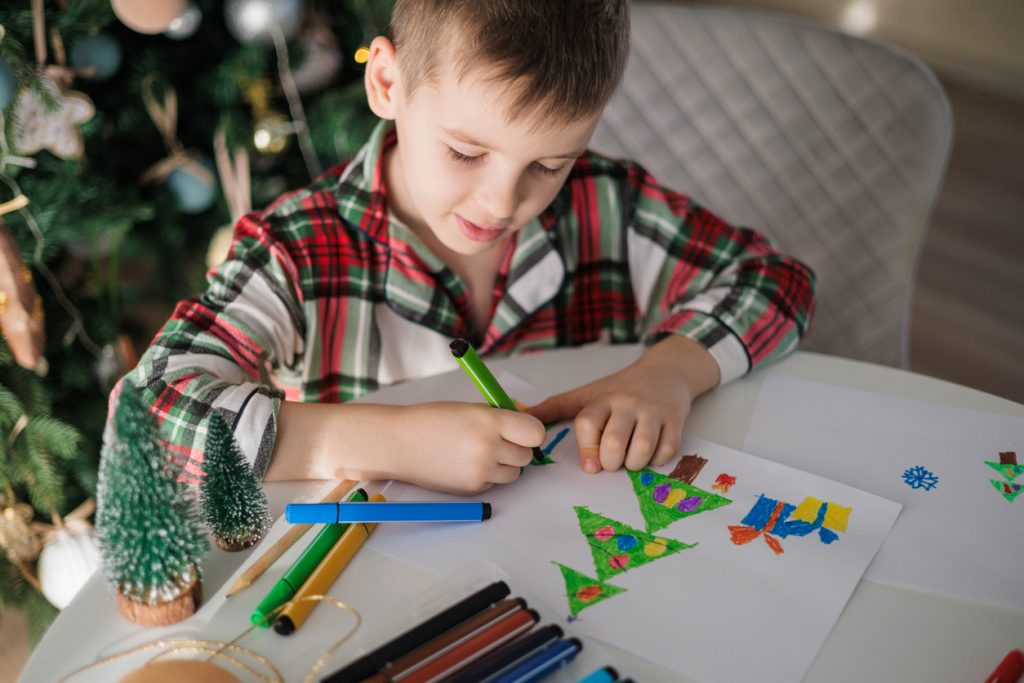 dijete uči kako nacrtati bor za božić